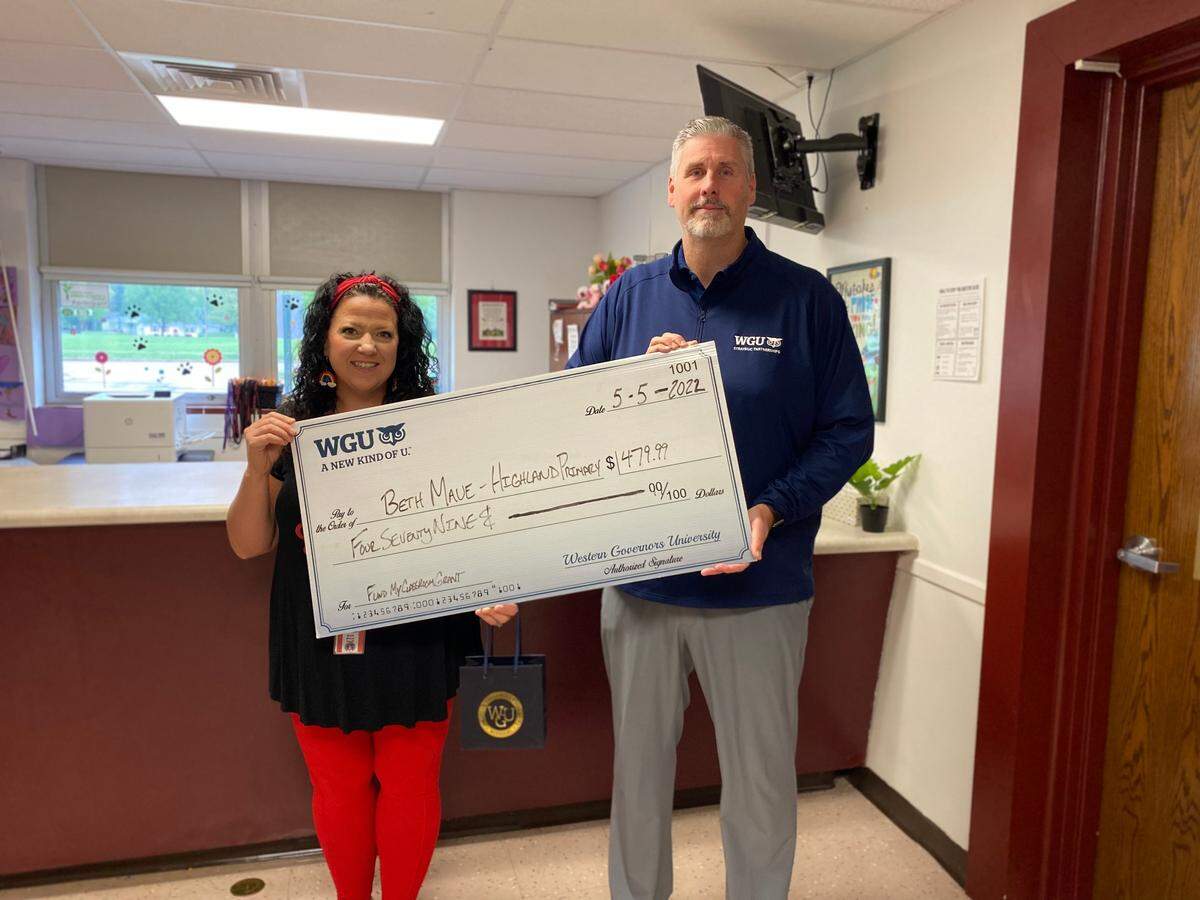 Beth Maue, a kindergarten special education teacher at Highland Primary School in Highland CUSD 5, has received a $480 grant through Western Governors University’s “Fund My Classroom” initiative. The funds will be used to purchase various materials to create a calming classroom environment for students to meet the growing needs in social emotional learning. Maue learned she was selected for the grant May 5 when WGU staff surprised her with a check presentation at her school. She is pictured with WGU Strategic Partnerships Manager Jim Chandler.