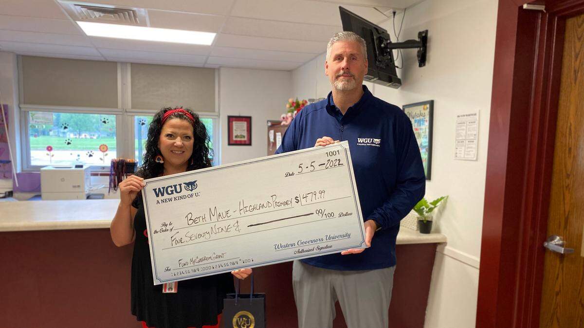 Beth Maue, a kindergarten special education teacher at Highland Primary School in Highland CUSD 5, has received a $480 grant through Western Governors University’s “Fund My Classroom” initiative. The funds will be used to purchase various materials to create a calming classroom environment for students to meet the growing needs in social emotional learning. Maue learned she was selected for the grant May 5 when WGU staff surprised her with a check presentation at her school. She is pictured with WGU Strategic Partnerships Manager Jim Chandler.