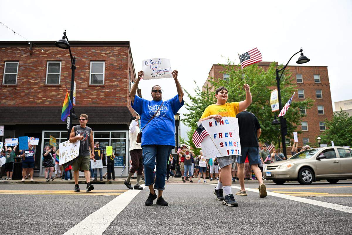Protesters rally against President Donald Trump at the “No Kings” protest in Belleville’s Public Square Saturday, June 14, 2025.