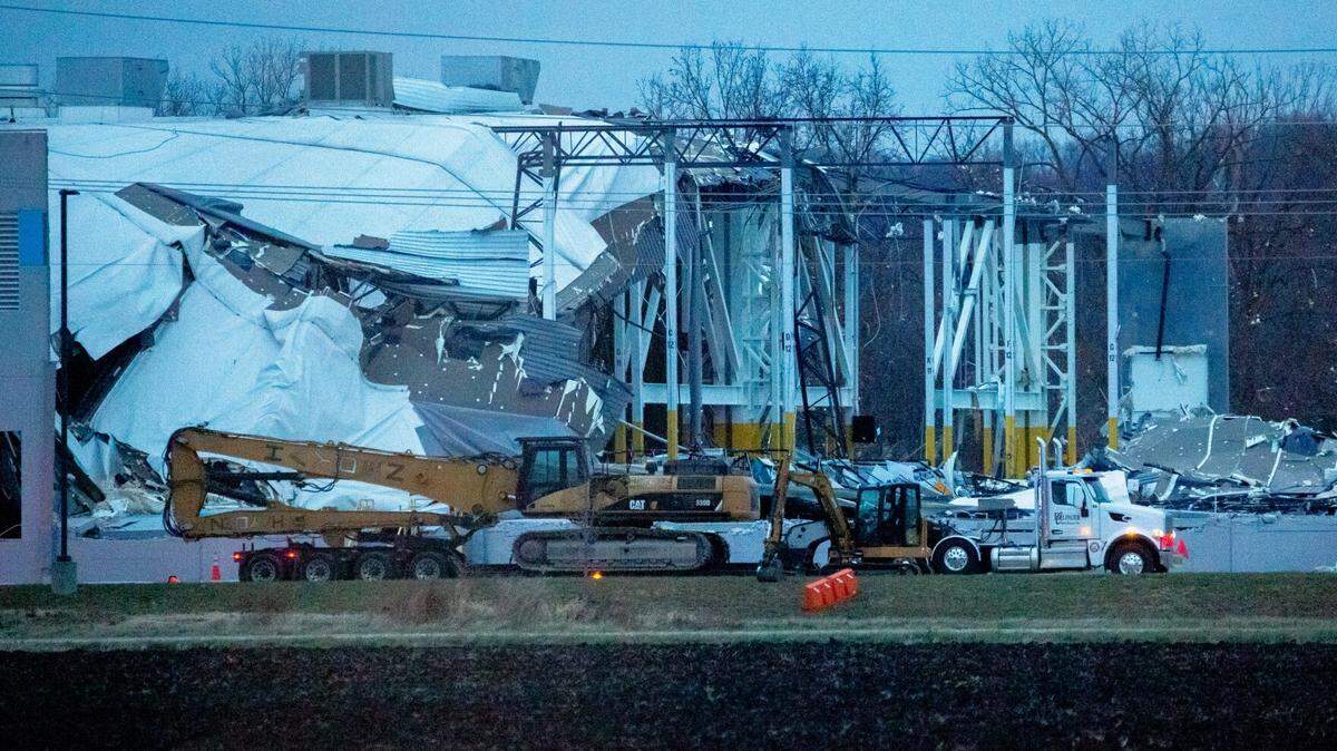 Workers attempt to clear debris as part of a search and rescue operation Dec. 11, 2021 at an Amazon Distribution Hub in Edwardsville.