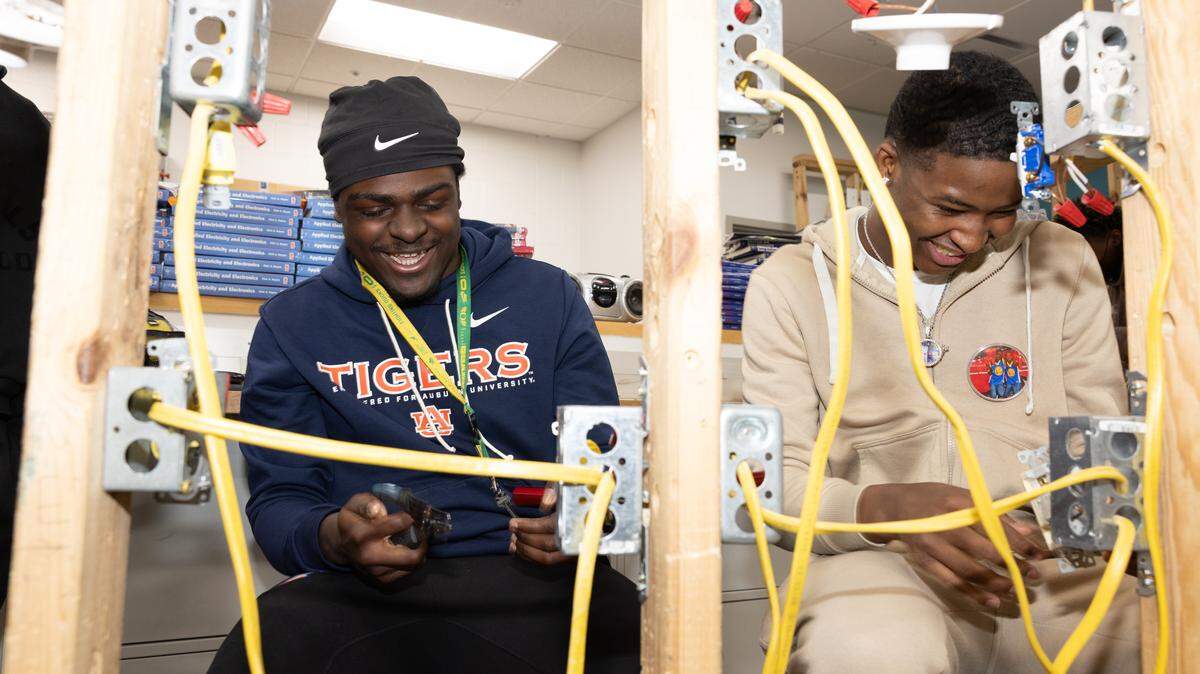 Students in an electrical class, part of East St. Louis Senior High’s career and technical education program, lay wires on frames they built themselves during class.