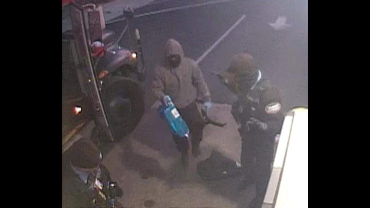 The FBI released this surveillance photo of the armed robbery of Brink’s armored vehicle drivers on Thursday at Regions Bank in Madison.