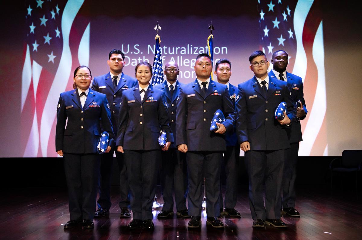 U.S. Air Force members of the 375th Civil Engineer Squadron and 375th Logistics Readiness Squadron stand for a group photo on Scott Air Force Base. Lt. Col. Ryan Leblanc, 375th CES commander, held a naturalization ceremony in honor of the eight Airmen in completing the process to obtain their U.S. citizenship with the help of the military.