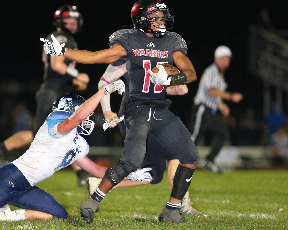 Granite City’s Montre Snead intercepts the ball and takes it back for a touchdown late in the fourth quarter during the Warriors win over Mater Dei Friday.