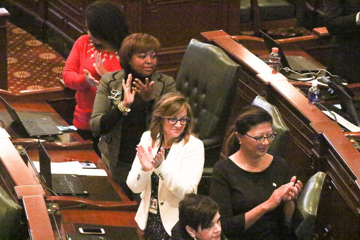 State Reps. LaToya Greenwood, D-East St. Louis, and Katie Stuart, D-Edwardsville, applaud during a legislator recognition during the 2018 veto session.