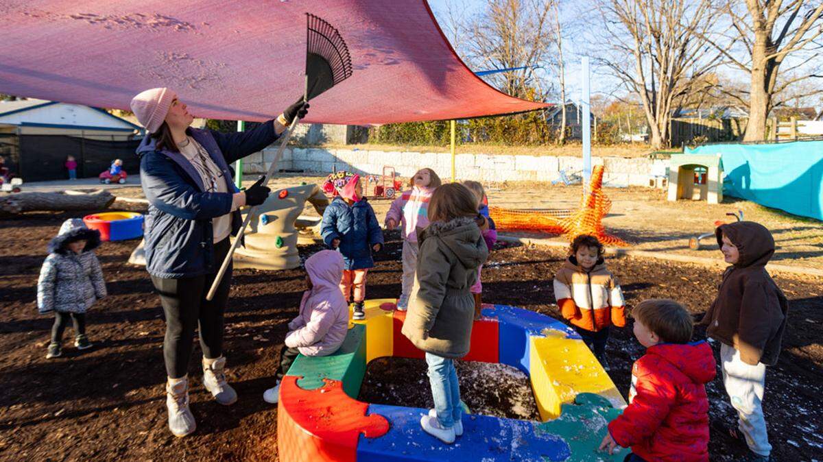 Children play outside at Our World of Learning Child Development Center in Alexander County in December 2024.