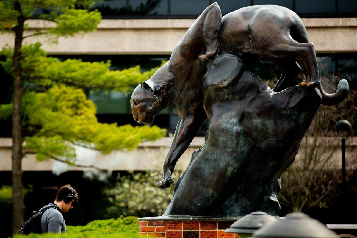 Students walk past Southern Illinois University Edwardsville’s Cougar Statue on Thursday, April 6, 2023, at the campus in Edwardsville.