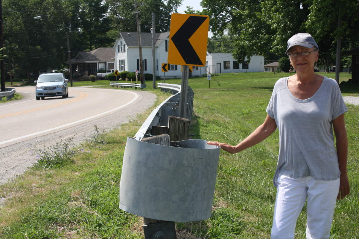 Shiloh resident Charlotte Cox in front of her home at 1705 Cross St., next to one of the guard rails off Cross Street where vehicles in the past have run off the road and into her yard. Cox, who filed a lawsuit against the village in St. Clair County that was recently dismissed, is concerned safety issues with traffic, pedestrians and cyclists will increase on Cross Street with the development's expected 311 units.