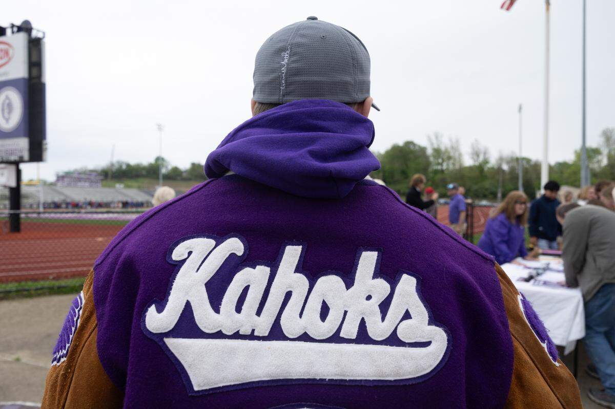 An alumni of Collinsville High School wears his letterman jacket from 1999.