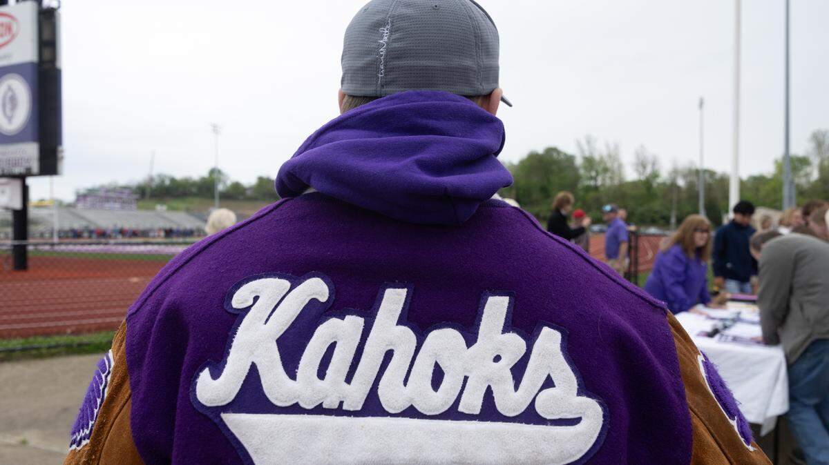 An alumna of Collinsville High School wears his letterman jacket from 1999.