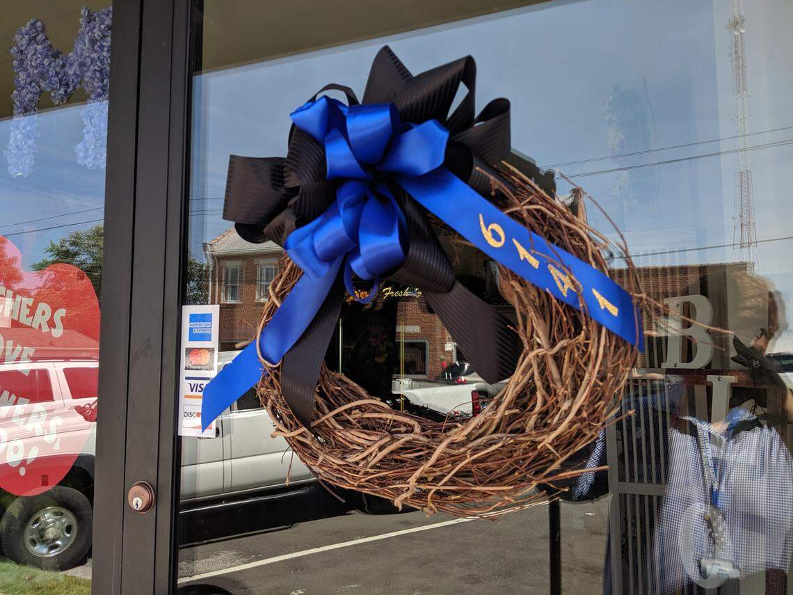 Waterloo business owner Shaundra Huebner pinned a black and blue ribbon to Bountiful Blossoms, her antique shop in Downtown Waterloo, as a way to show support for fallen Illinois State Trooper Nick Hopkins’ family. She said it’s important during tragedies for small towns to come together.