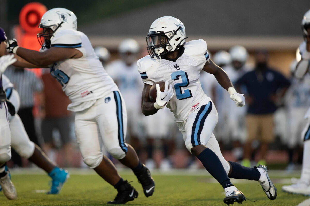 Belleville East’s Markevious Curiton carries the ball during Friday night’s season opener against Collinsville. The Lancers ultimately prevailed 20-12.