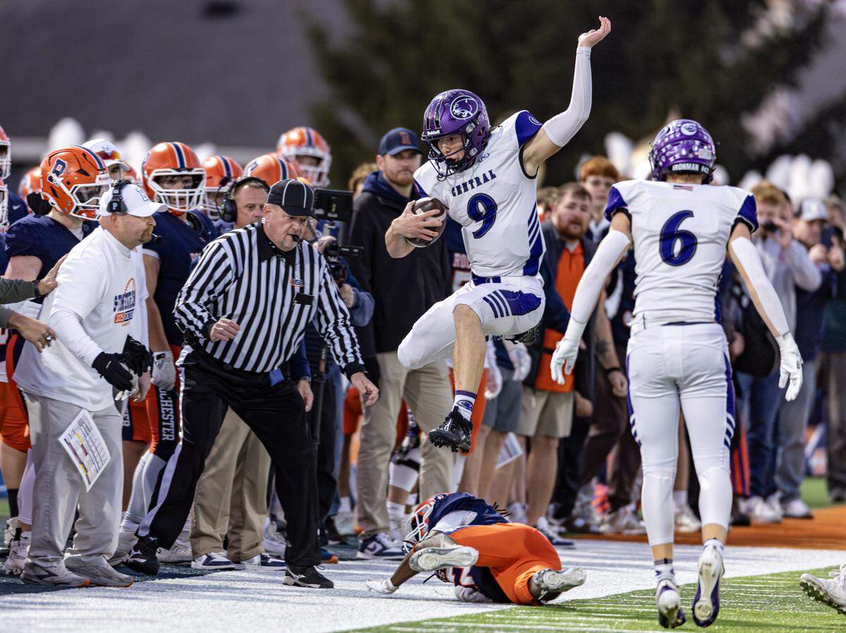 Breese Central sophomore quarterback Owen Kehrer leaps a defender for extra yards in a IHSA Class 4A state football semifinal game in Rochester Saturday.