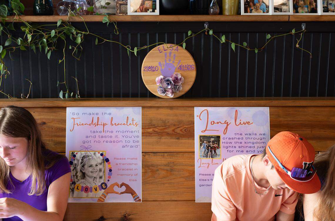 Teens paint rocks while a memorial to Elsie Wiemerslage sits in the background during the late teen’s celebration of life at a Waterloo restaurant Friday. Memorials to Elsie were evident in shirts, signs, illustrations and photographs.