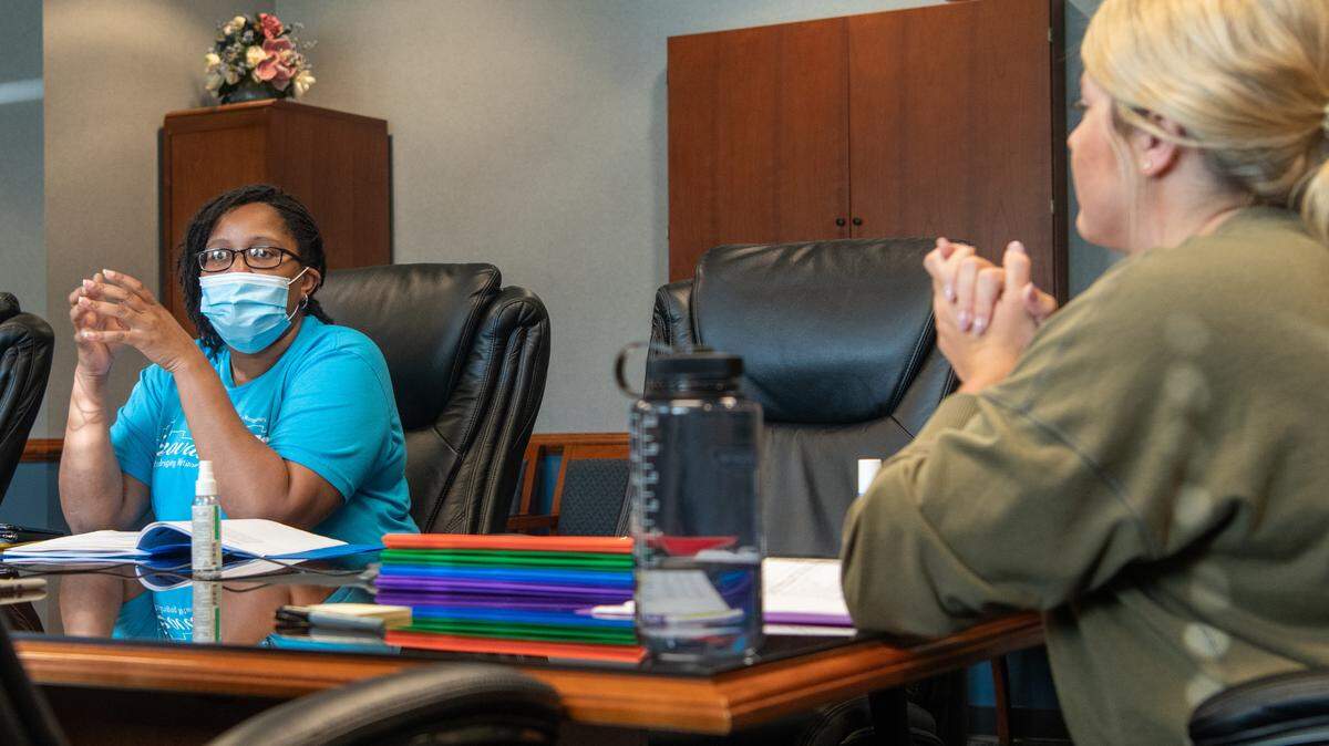 U.S. Air Force Senior Airman Mikayla Hill, 435th Supply Chain Operations Squadron general stock funds manager, listens as book club members tell their personal stories of resilience at Scott Air Force Base. The club was started to promote difficult discussions to improve units by allowing members to open up about their life experiences without fear of retribution.