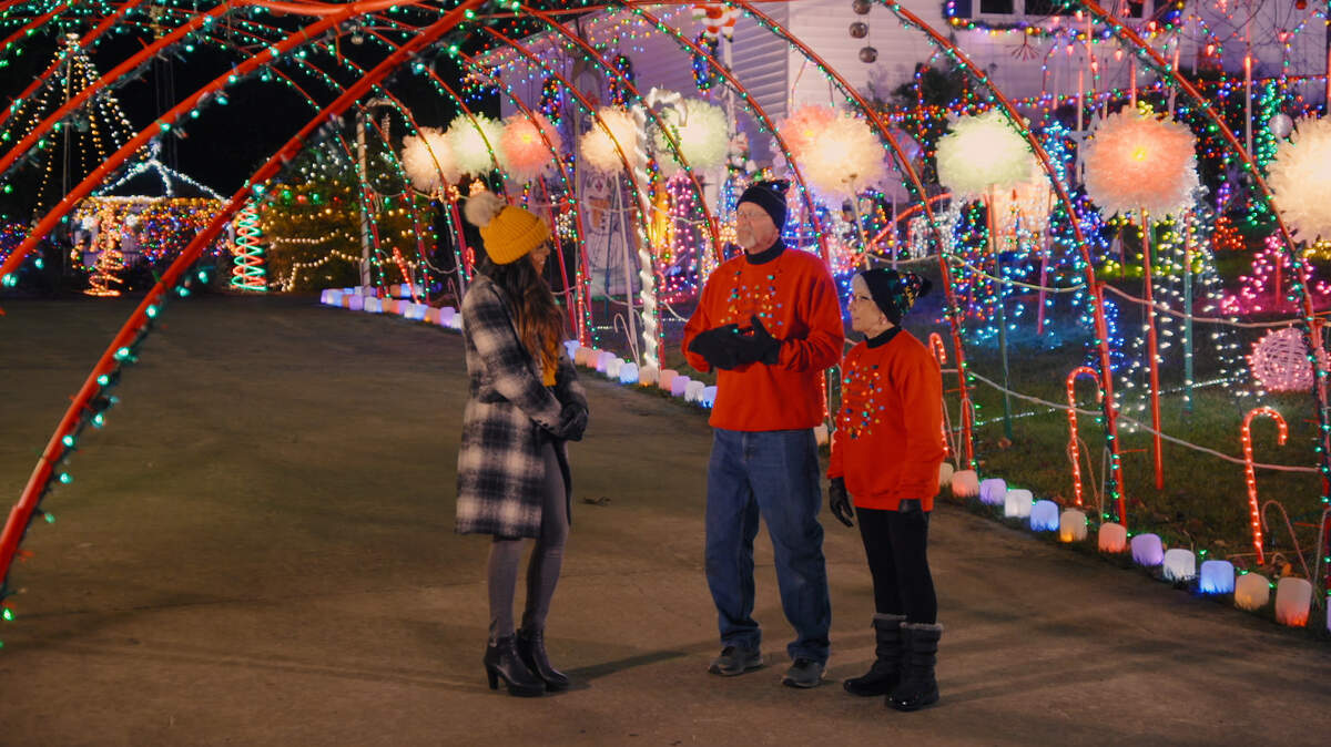 A host of ABC’s “The Great Christmas Light Fight” speaks to the Kittells, of Chester, Ill., while filming in this image released by ABC.