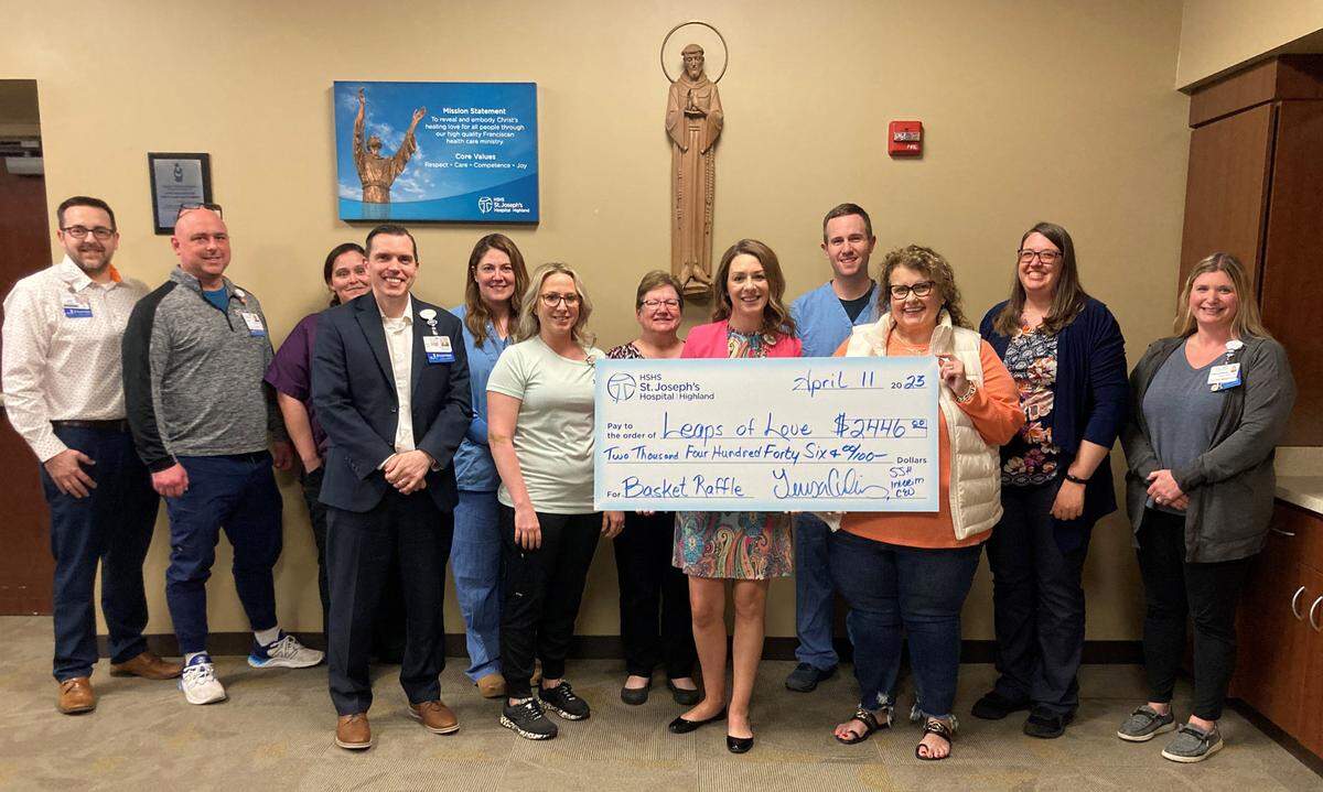 HSHS St. Joseph’s Hospital Highland colleagues and Mission committee held a basket raffle in March to support Leaps of Love. The raffle raised over $2,400 for the local organization which embraces families affected by childhood brain tumors, late-effects of childhood cancer, and predisposition syndrome by providing hope, strength, and encouragement. Shown at the check presentation are (left to right): Jed Driemeyer, director of human resources; Patrick Small, manager of emergency services; Trisha Ernst, director of environmental services; Mark Ennen, director of finance; Megan Espenschied, director of surgical services and medical imaging; Michelle Herzberg, director of inpatient services; Sheri Ernst, executive assistant; Teresa Cornelius, interim president and CEO; Abe Barth, pharmacist; Judy Neir, Leaps of Love representative; Rebecca Niemerg, spiritual care team lead; and Hillary Newman, manager of supply chain.