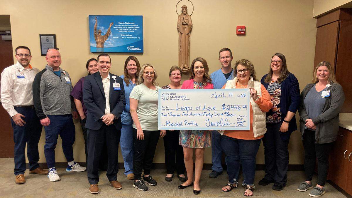 HSHS St. Joseph’s Hospital Highland colleagues and Mission committee held a basket raffle in March to support Leaps of Love. The raffle raised over $2,400 for the local organization which embraces families affected by childhood brain tumors, late-effects of childhood cancer, and predisposition syndrome by providing hope, strength, and encouragement. Shown at the check presentation are (left to right): Jed Driemeyer, director of human resources; Patrick Small, manager of emergency services; Trisha Ernst, director of environmental services; Mark Ennen, director of finance; Megan Espenschied, director of surgical services and medical imaging; Michelle Herzberg, director of inpatient services; Sheri Ernst, executive assistant; Teresa Cornelius, interim president and CEO; Abe Barth, pharmacist; Judy Neir, Leaps of Love representative; Rebecca Niemerg, spiritual care team lead; and Hillary Newman, manager of supply chain.