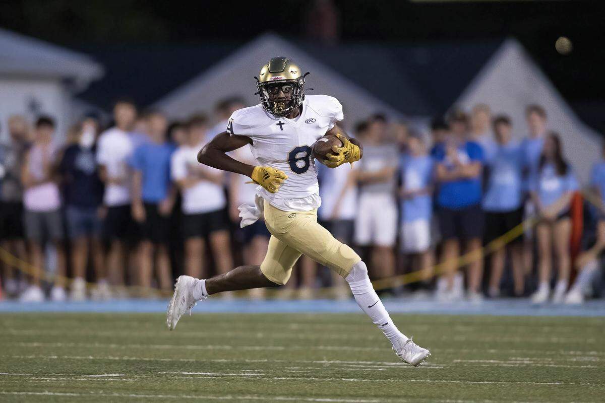 Althoff’s Taylor Powell carries the ball against Mater Dei on Friday night. The Crusaders ultimately prevailed 13-7.