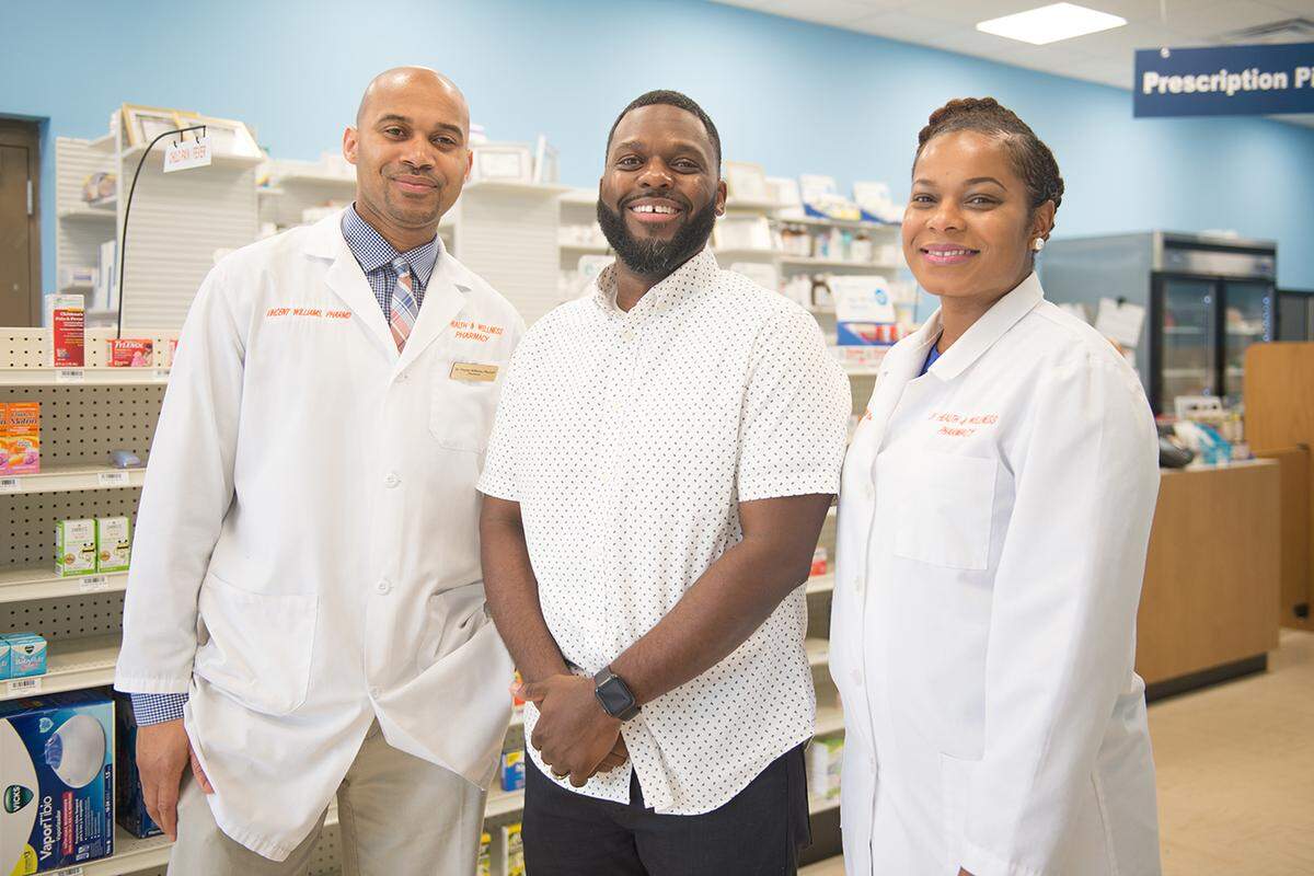 “They completely went above and beyond,” says Bernard Macon (center) of Vincent and Lekeisha Williams, owners of LV Health and Wellness Pharmacy in Shiloh, Ill. (Michael B. Thomas for Kaiser Health News)