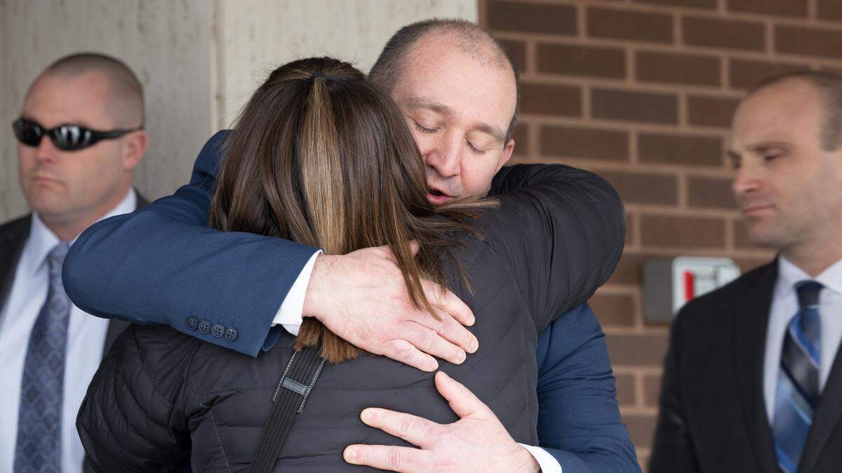 Assistant State’s Attorney Luke Yager hugs Jenny Hosler on Monday outside the Madison County Criminal Justice Center in Edwardsville after a jury found her brother, Neil Howard, guilty of killing their mother.