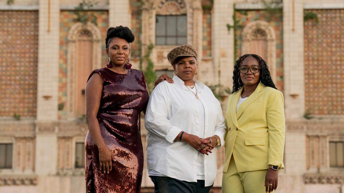 Larita Rice-Barnes (left), Terra Jenkins (center), and April Roby-Bell work behind the scenes in East St. Louis, Illinois, and its surrounding communities to help grieving families after tragedies. The three women grew up around street gangs and now fill in the gaps for a community overwhelmed by gun violence. (Whitney Curtis for KHN)
