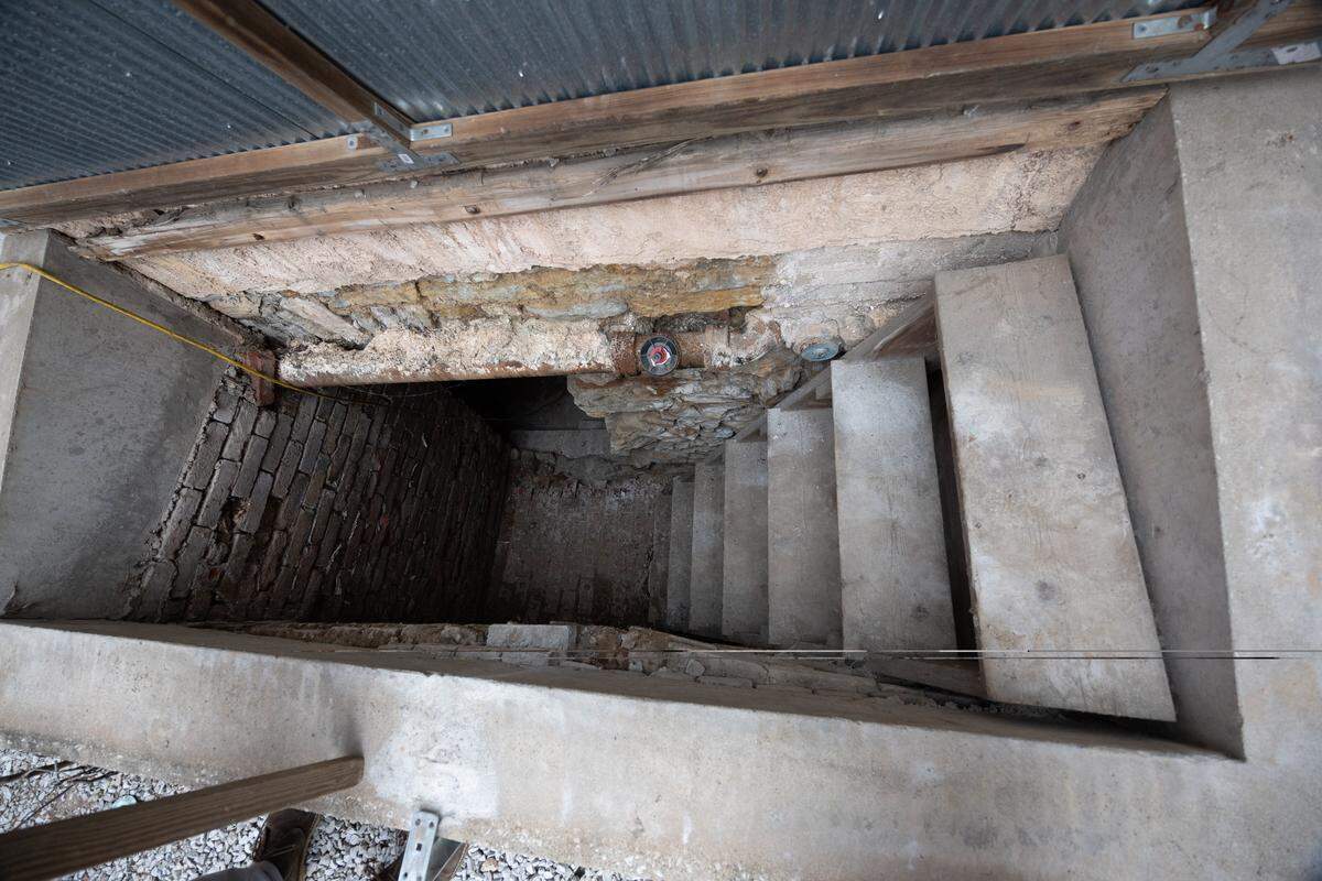 To get to the cellar, you have to climb down a steep set of stairs.