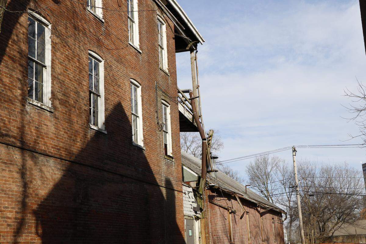 The side of one of the dilapidated properties on Main Street in Highland. The buildings are planned to be razed and become parking lots, which the city hopes will help bring more business to the Downtown Square.