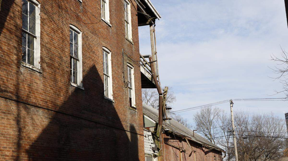 The side of one of the dilapidated properties on Main Street in Highland. The buildings are planned to be razed and become parking lots, which the city hopes will help bring more business to the Downtown Square.