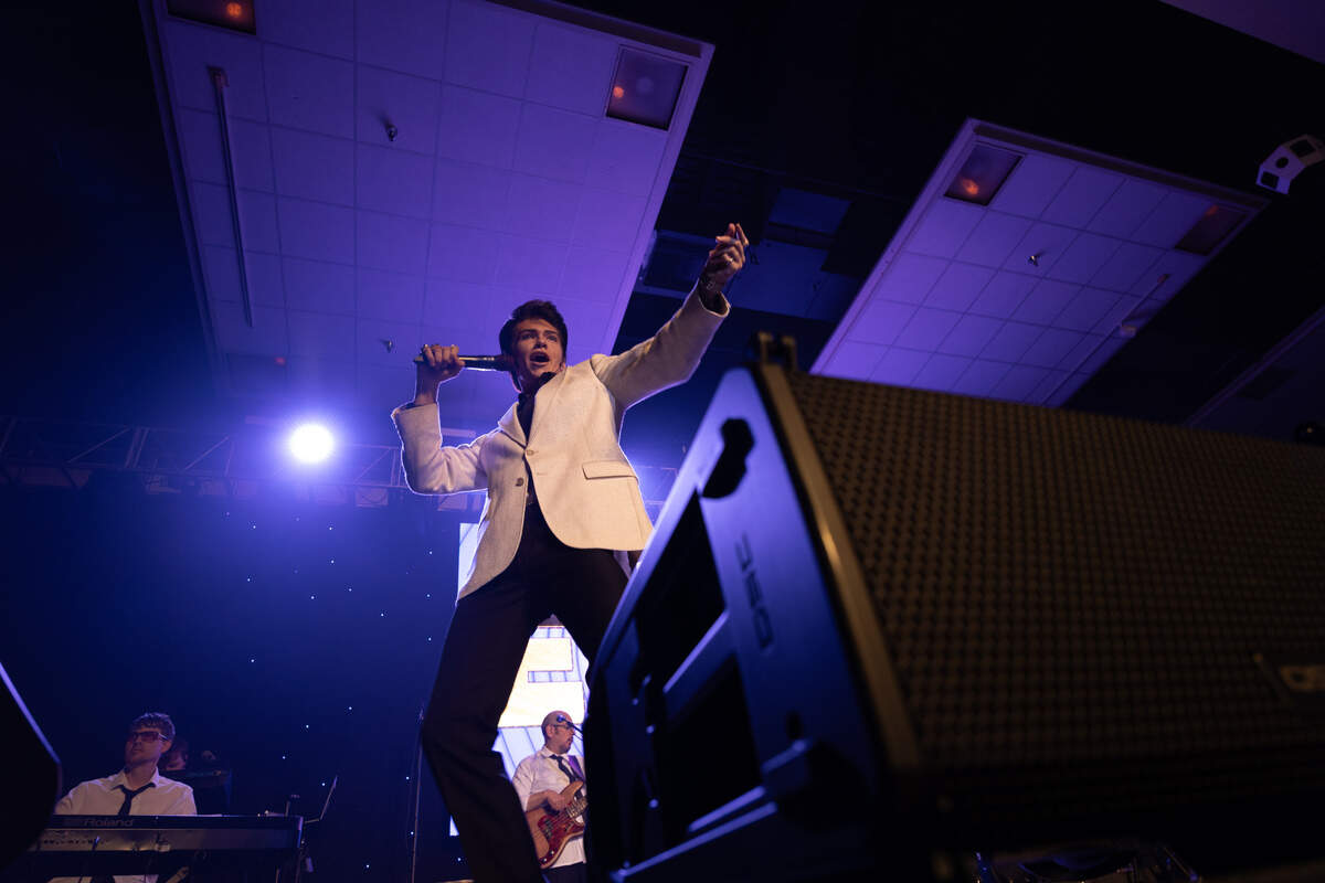 Finley Watkins dances in the fashion of Elvis Presley while performing “A Little Less Conversation” at the Gateway Convention Center.