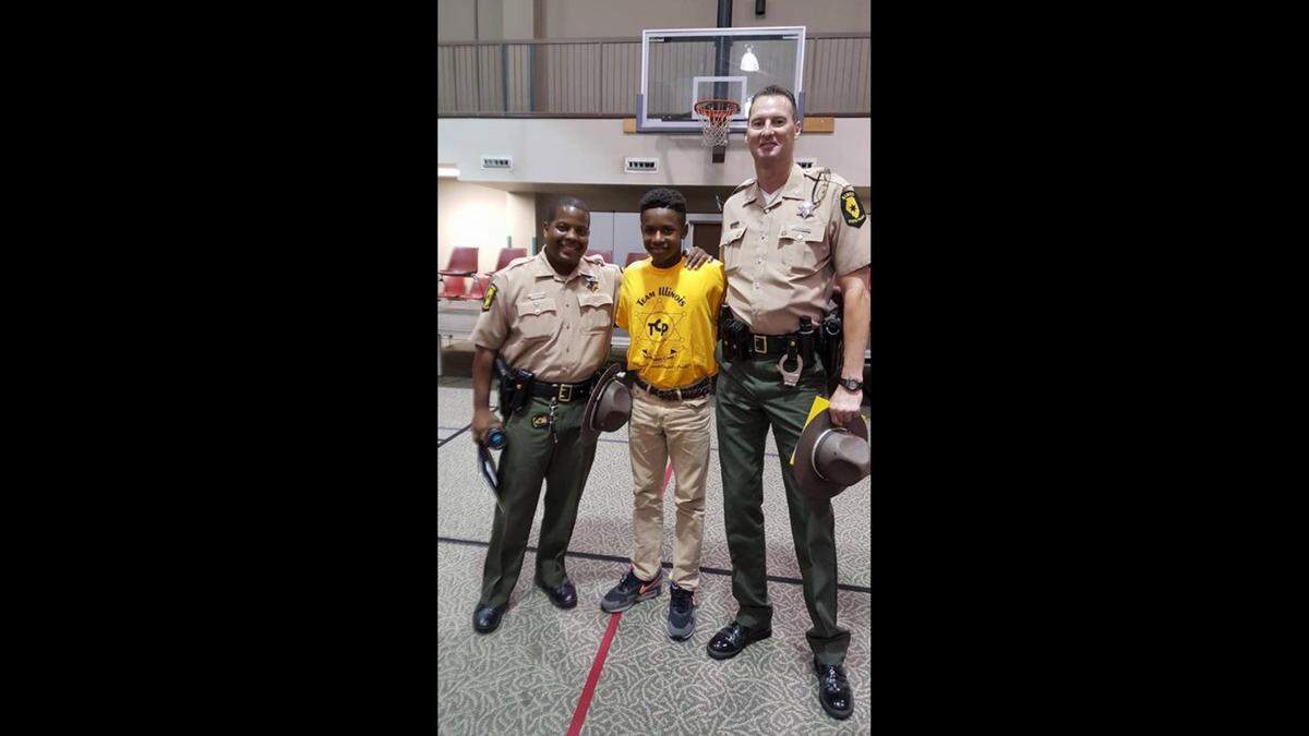 From left, Illinois State Police Master Sgt. Calvin “Buddy” Dye Jr., then-cadet Dominic Lovett, and Illinois State Police Trooper Jeffrey Bishop at graduation of the Team Illinois Youth Police Camp. Lovett was recently drafted as a wide receiver by the Detroit Lions, and credits the youth camp for today’s successes.