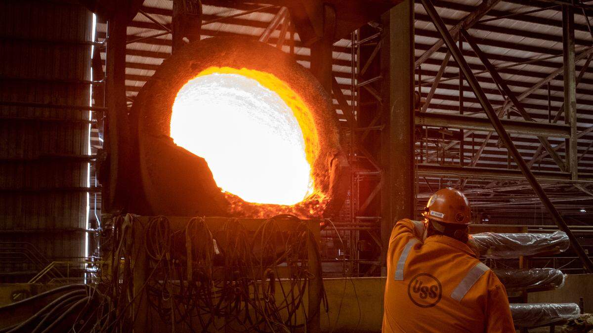 A U. S. Steel worker inspects equipment after emptying a pot of liquid steel in this 2018 file photo.