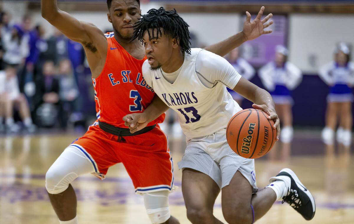 Collinsville’s Ray’Sean Taylor drives to the basket against East St. Louis’ Jabril Olivera during Tuesday’s Southwestern Conference game. The Kahoks rolled to a 51-36 triumph.