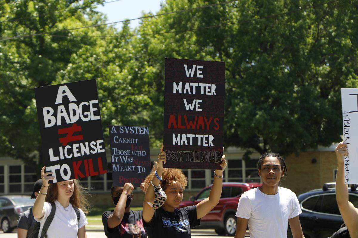 Demonstrators march through the streets of Mascoutah Saturday, June 13, in protest of racist policing and the killing of George Floyd.. The protest was one of many held in metro-east cities over the past several weeks.