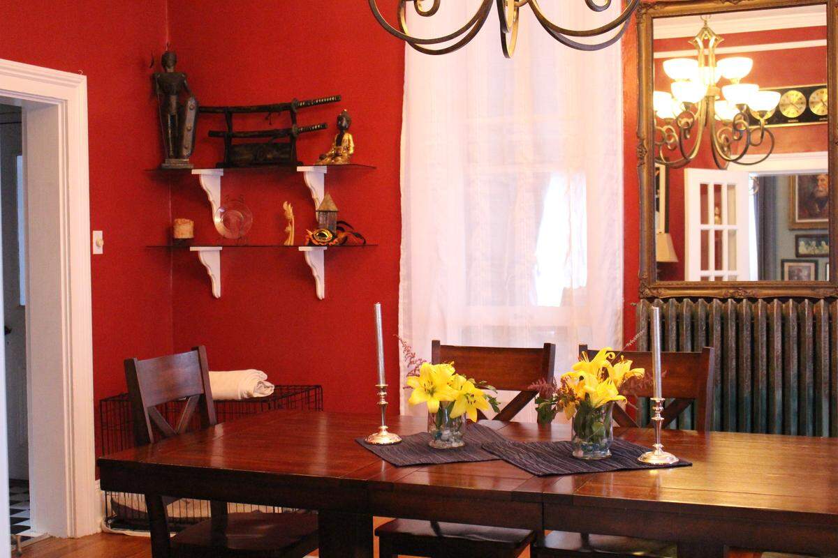 The dining room in the McCullough family’s 1874 brick home on Abend Street in Old Belleville Historic District has a high ceiling, tall windows and an old-fashioned radiator.