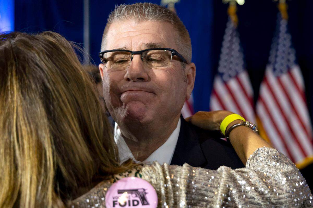 Republican gubernatorial candidate Darren Bailey, right, hugs a supporter after conceding to Gov. J.B. Pritzker on election night Tuesday, Nov. 8, 2022, at the Crowne Plaza in Springfield, Ill. (Brian Cassella/Chicago Tribune via AP)