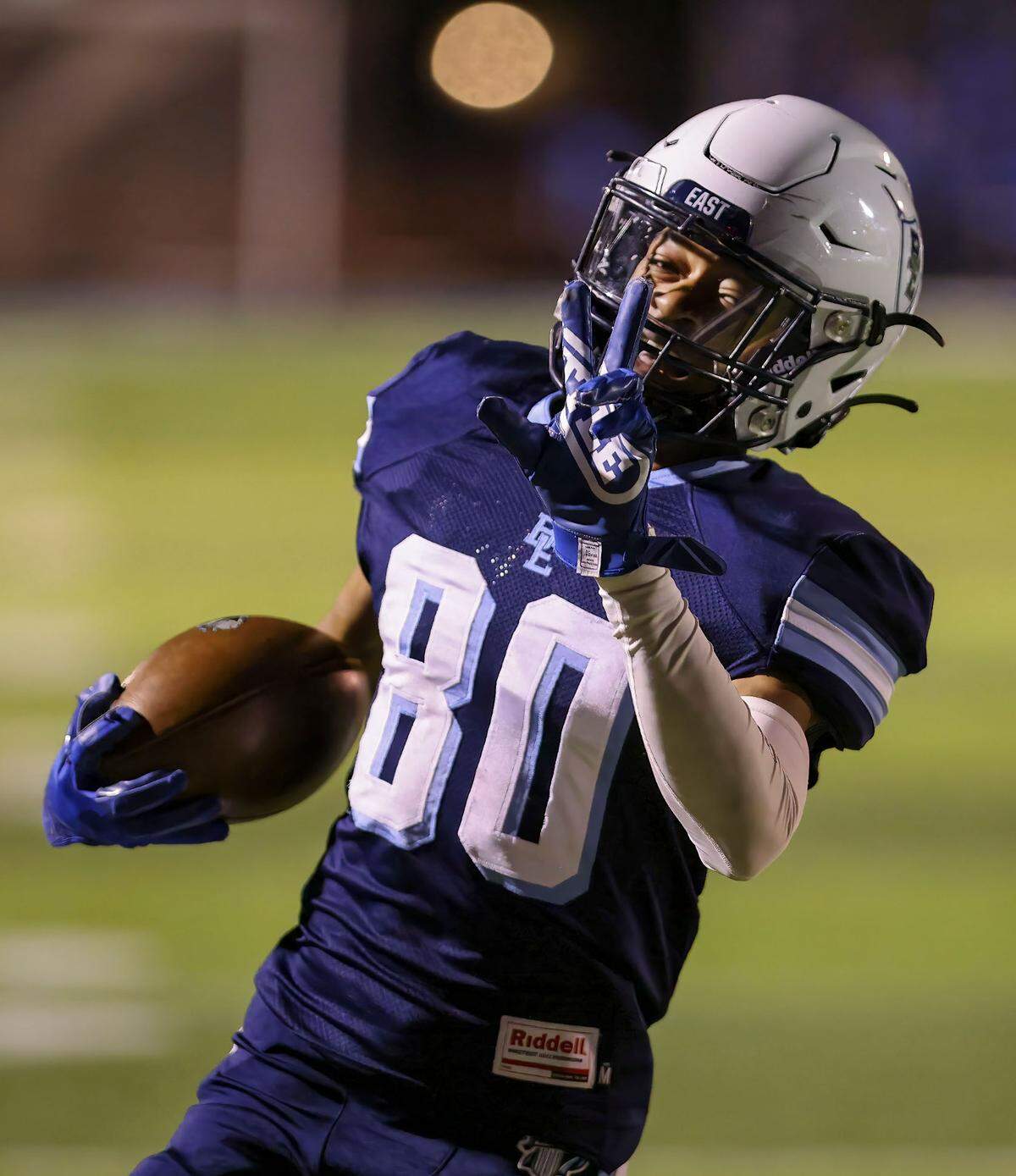 Belleville East’s Justin Spears celebrates a touchdown during Friday night’s non-conference game against Granite City. The Lancers defeated the Warriors to become playoff eligible.