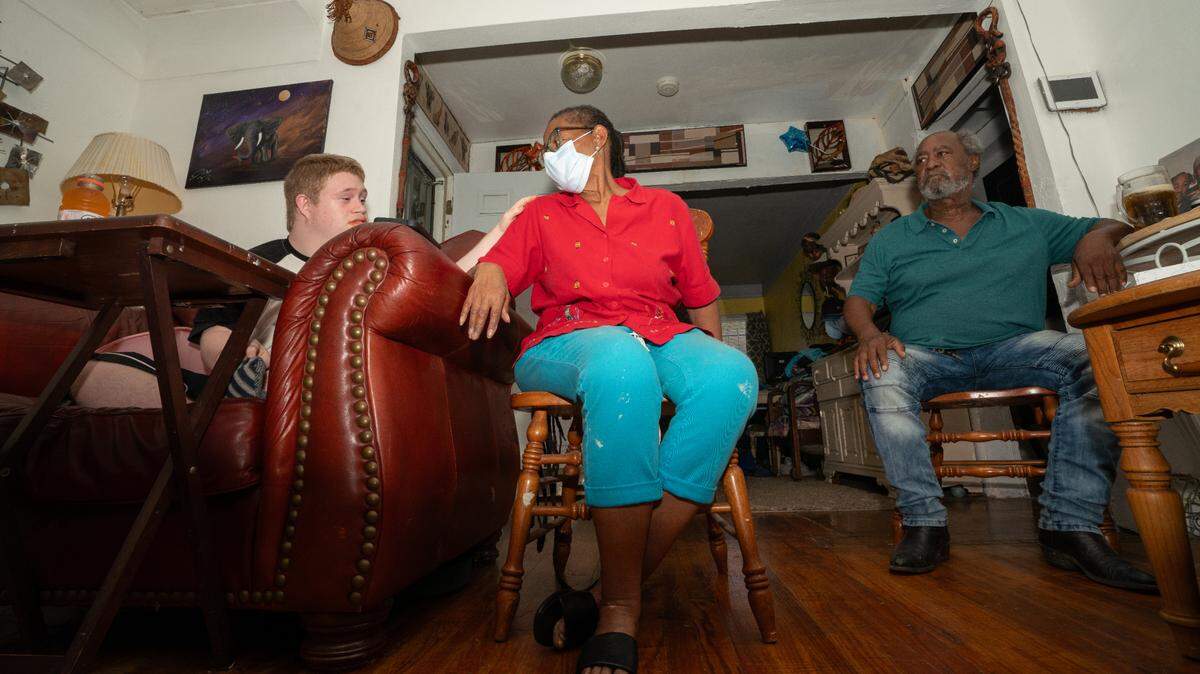 Arthur, Patricia and Lonnie Greenwood sit together in their Cahokia Heights home. Each member of the family has health problems they believe were caused by the sewage and flood water entering their house for decades because of infrastructure and drainage issues in the city.