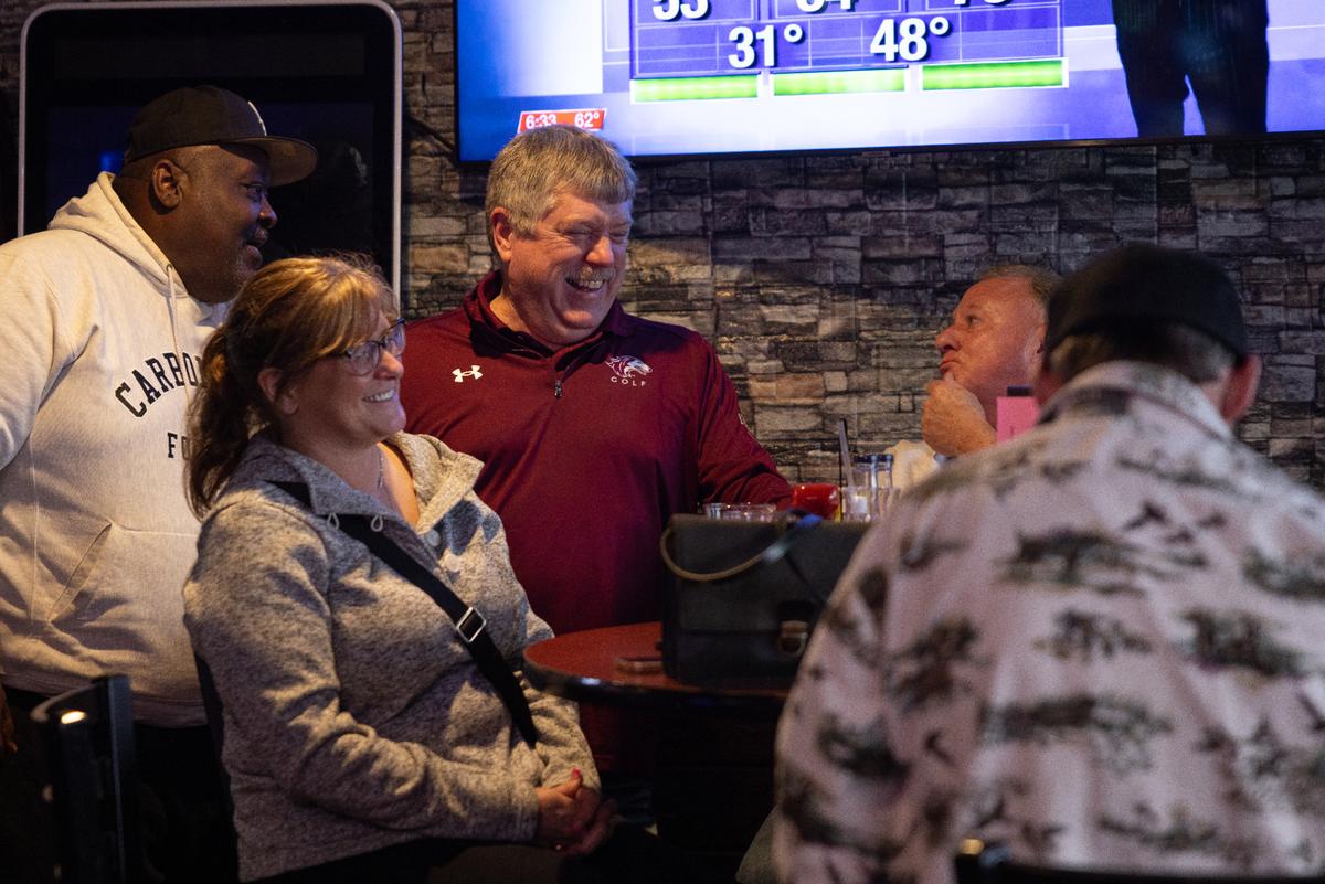 Jeff Vaughn, 58, center, enjoys a drink with friends at the restaurant he owns, Tres Hombres, Saturday, March 15 in Carbondale, Illinois. “Just 11,000 people coming into town,” he said of SIU students, “ All the jobs from custodians to professors and administrators, all those people come to Carbondale because of the university.” (Julia Rendleman for ProPublica)
