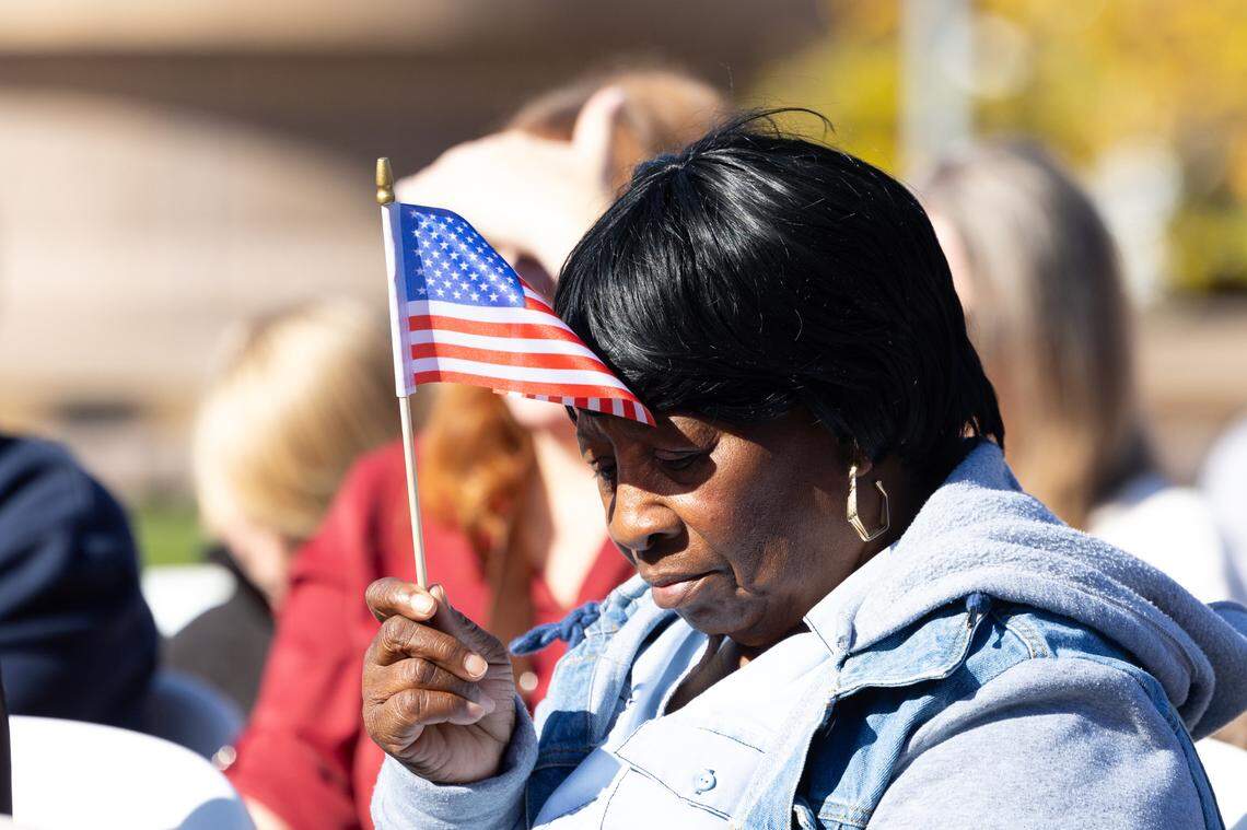 An event-goer shields her eyes from the bright midday sun during Belleville’s 26th annual Veterans Day ceremony on Nov. 11, 2024.