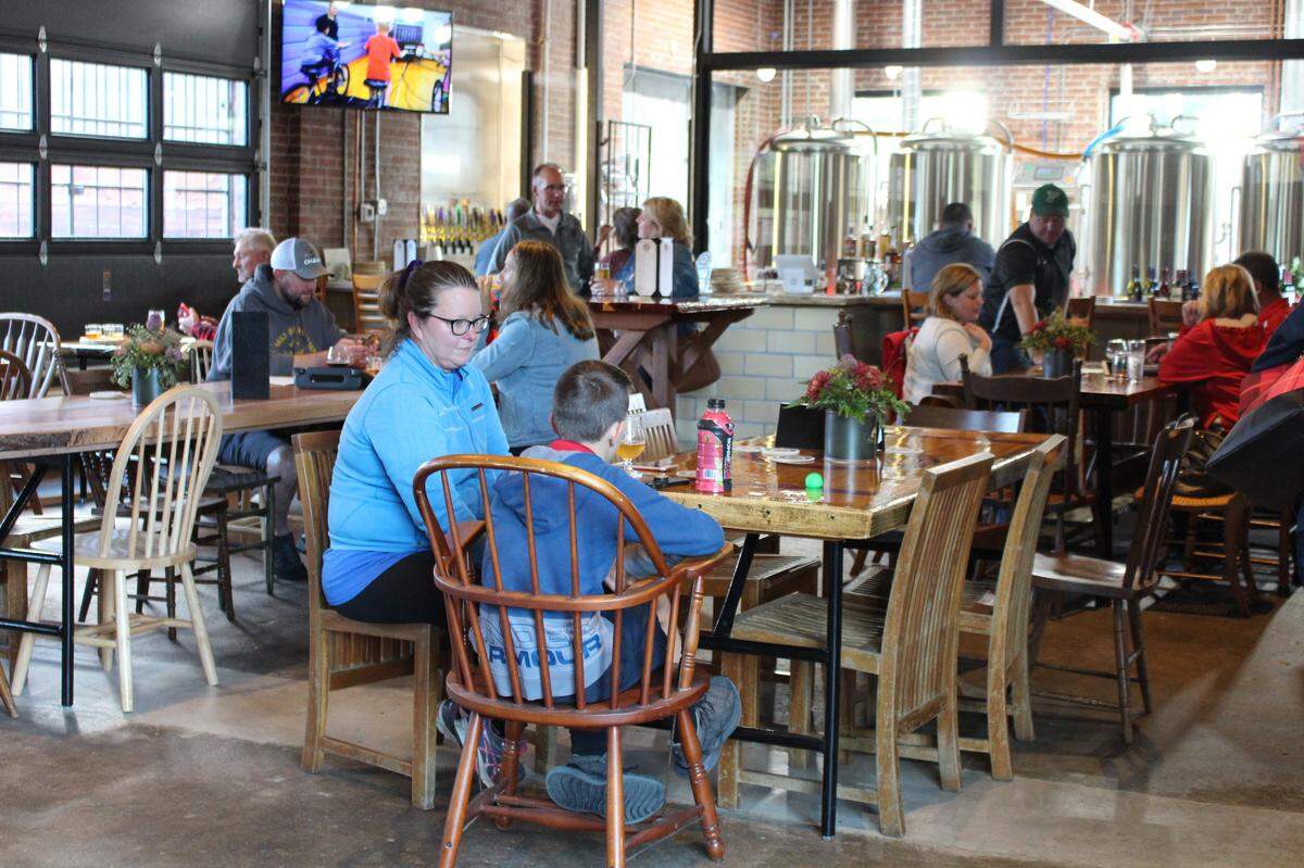 The main tasting room at Millpond Brewing & Incubator in Millstadt has a 16-foot ceiling, exposed brick walls and garage doors that can be raised for an open-air atmosphere.