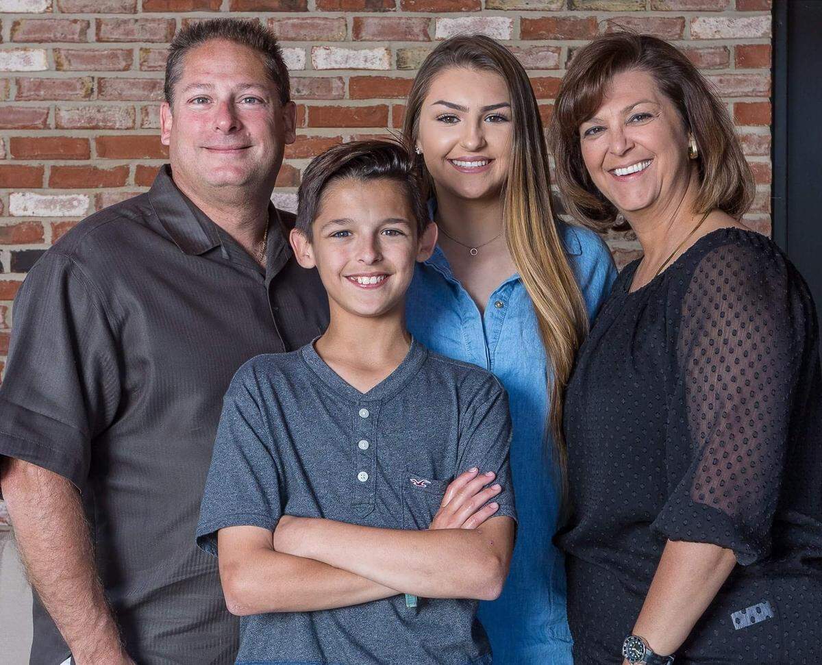 Isabell Suria, second from right, who committed suicide shortly after her 18th birthday, is shown in happier times with her father, Rick, mother Laura and brother Logan, now 15.