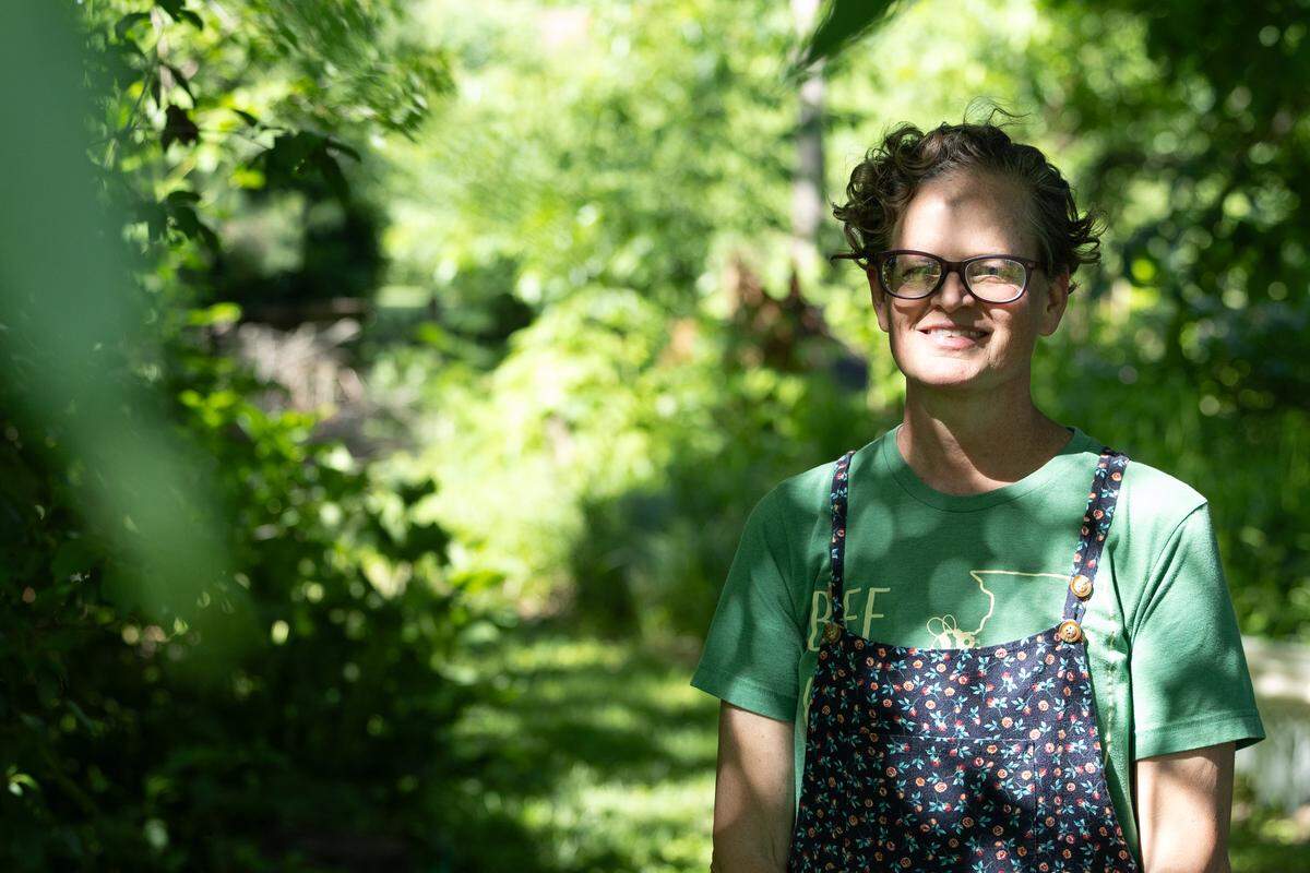 Laura Schaefer stands inside her native plant garden in Millstadt on June 3, 2026. In addition to fighting Stage IV cancer, Schaefer also withstood citations from the city, which claimed her native plant garden violated regulations on weed and grass length.