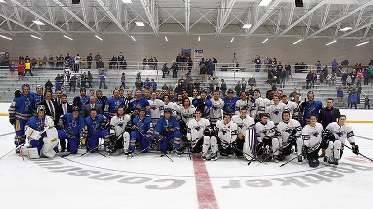 Members of the St. Louis Blues alumni get together for a photo with members of the McKendree University men’s hockey team in O’Fallon.