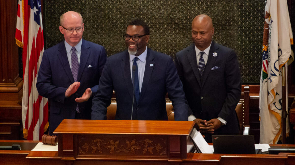 Chicago Mayor-elect Brandon Johnson (center) delivers an address to a joint session of the General Assembly Wednesday in the Illinois House chamber. He is pictured with Senate President Don Harmon, (left) D-Oak Park, and House Speaker Emanuel “Chris” Welch, D-Hillside.