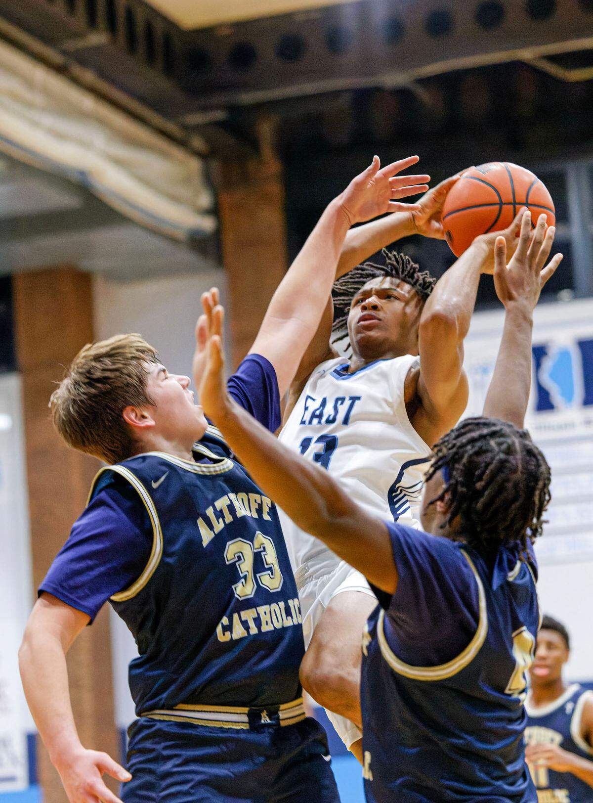 Belleville East’s Jackson Muse shoots over Althoff’s Patton Leib during Tuesday’s non-conference game. The Lancers ultimately posted a 78-50 victory.