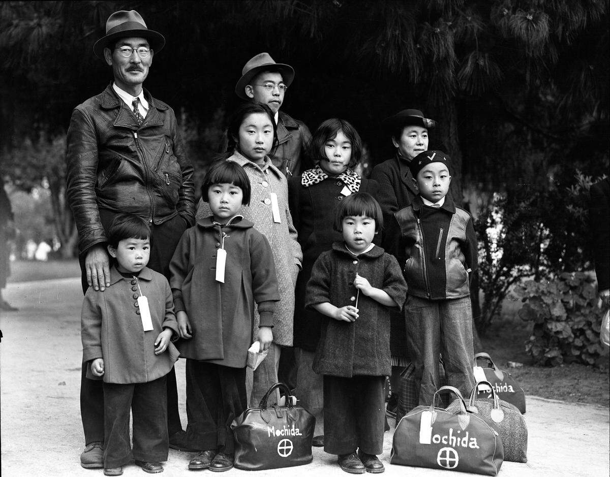 The Smithsonian traveling exhibition, “Righting a Wrong: Japanese Americans and World War II” opens Saturday, July 24, at Soldiers Memorial Military Museum in St. Louis. Pictured: The Mochida family, wearing identification tags awaits a bus. They were forced to leave their two-acre nursery and greenhouse in Eden, California, May 1942. “Dorthea Lange, Courtesy of National Archives.”