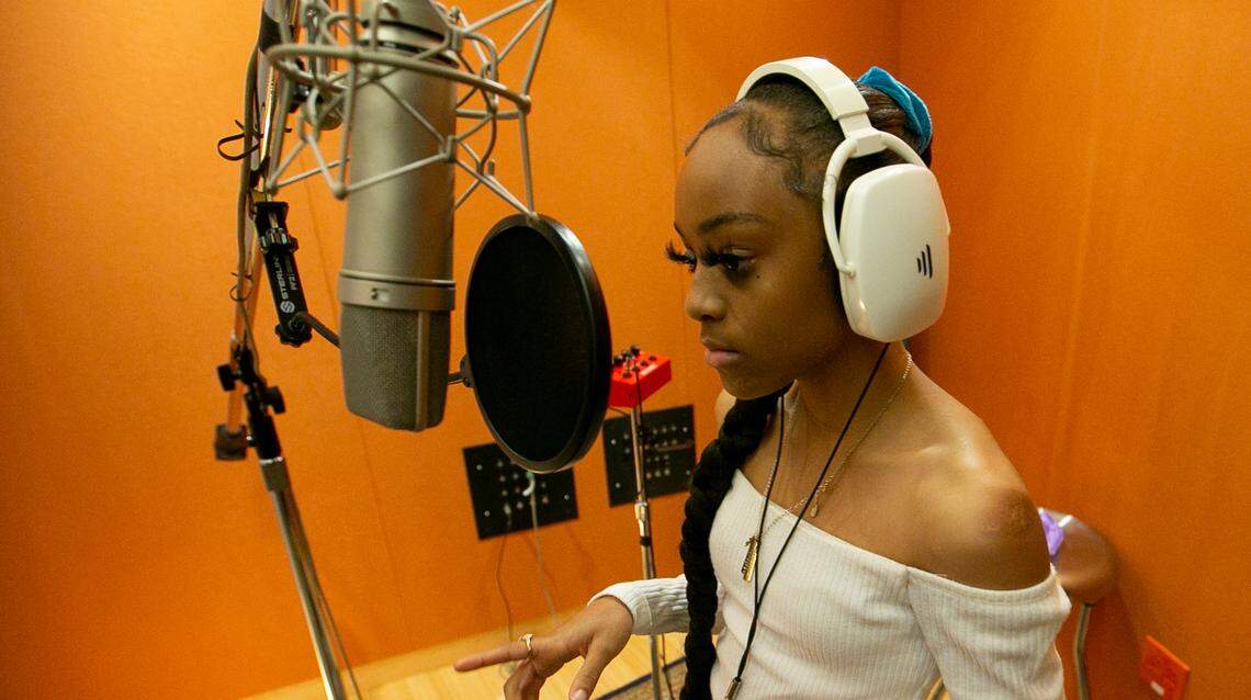Jordyn Powell, better known as Jaiimoni Starr, listens to her recording engineer as she works in the recording studio at Shock City Studios in St. Louis. A viral Tik Tok video laid the foundation for the East St. Louis native’s budding rap career.