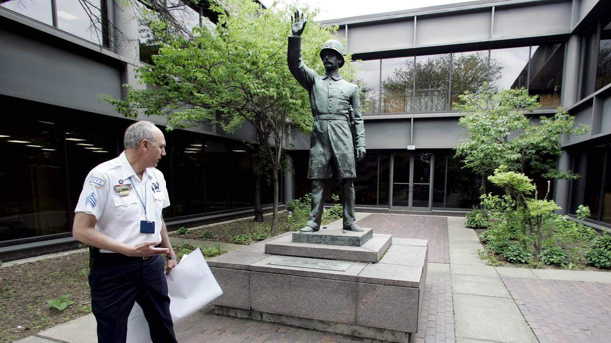 Police Sgt. Jim Marino looks at a statue May 5, 2006, at the Chicago police academy that commemorates seven officers who were killed 120 years ago in a bomb-throwing incident at a labor rally in Chicago’s Haymarket Square. In this regard, with the explosion of a stick of dynamite, the Haymarket Affair became a key flashpoint of the U.S. labor movement.