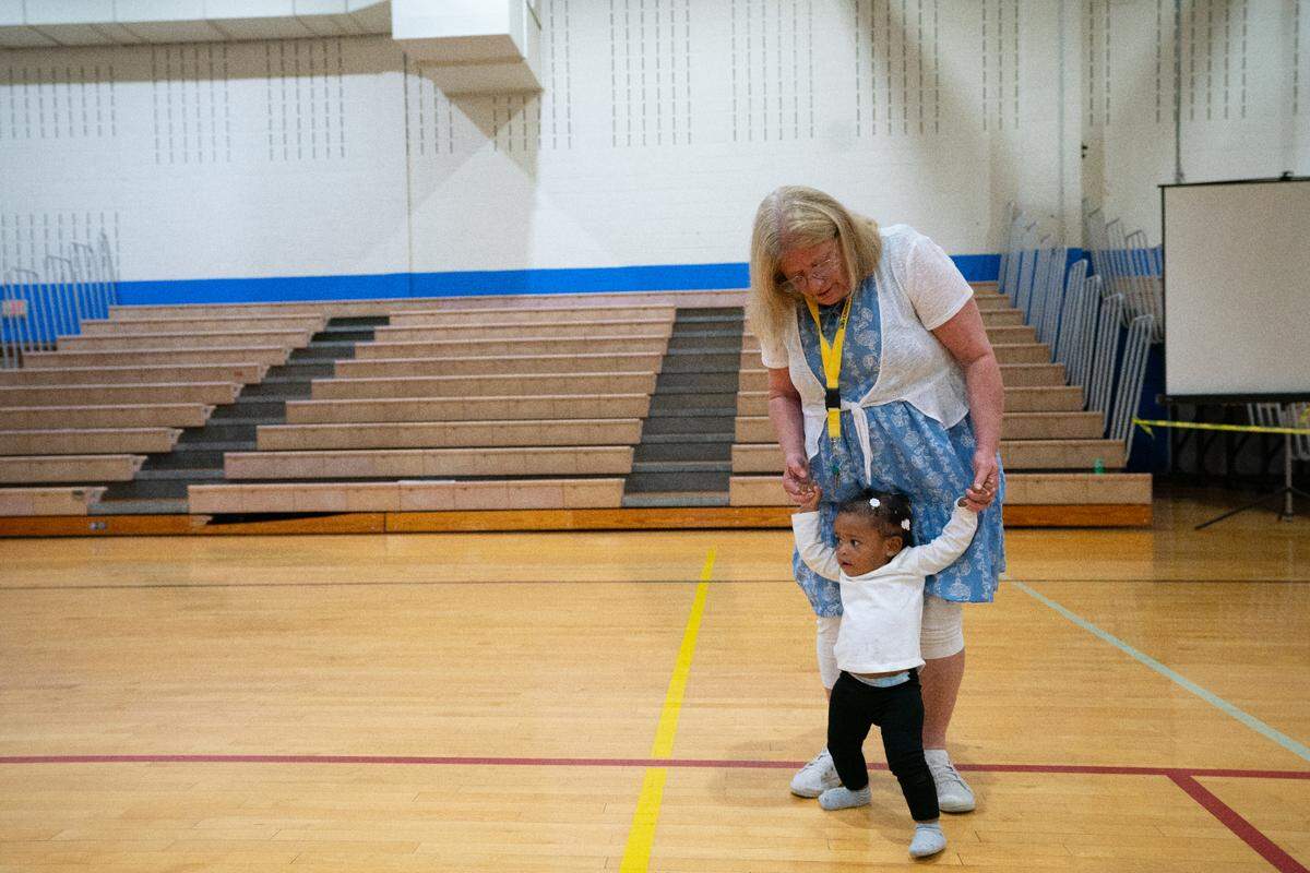 Debbie Duncan plays with the granddaughter of a temporary resident at the Cahokia Heights Fitness and Community Center on Oct. 26, 2023. “Oh, I’m not doing this for work,” Duncan said, “I’m just here to help.”